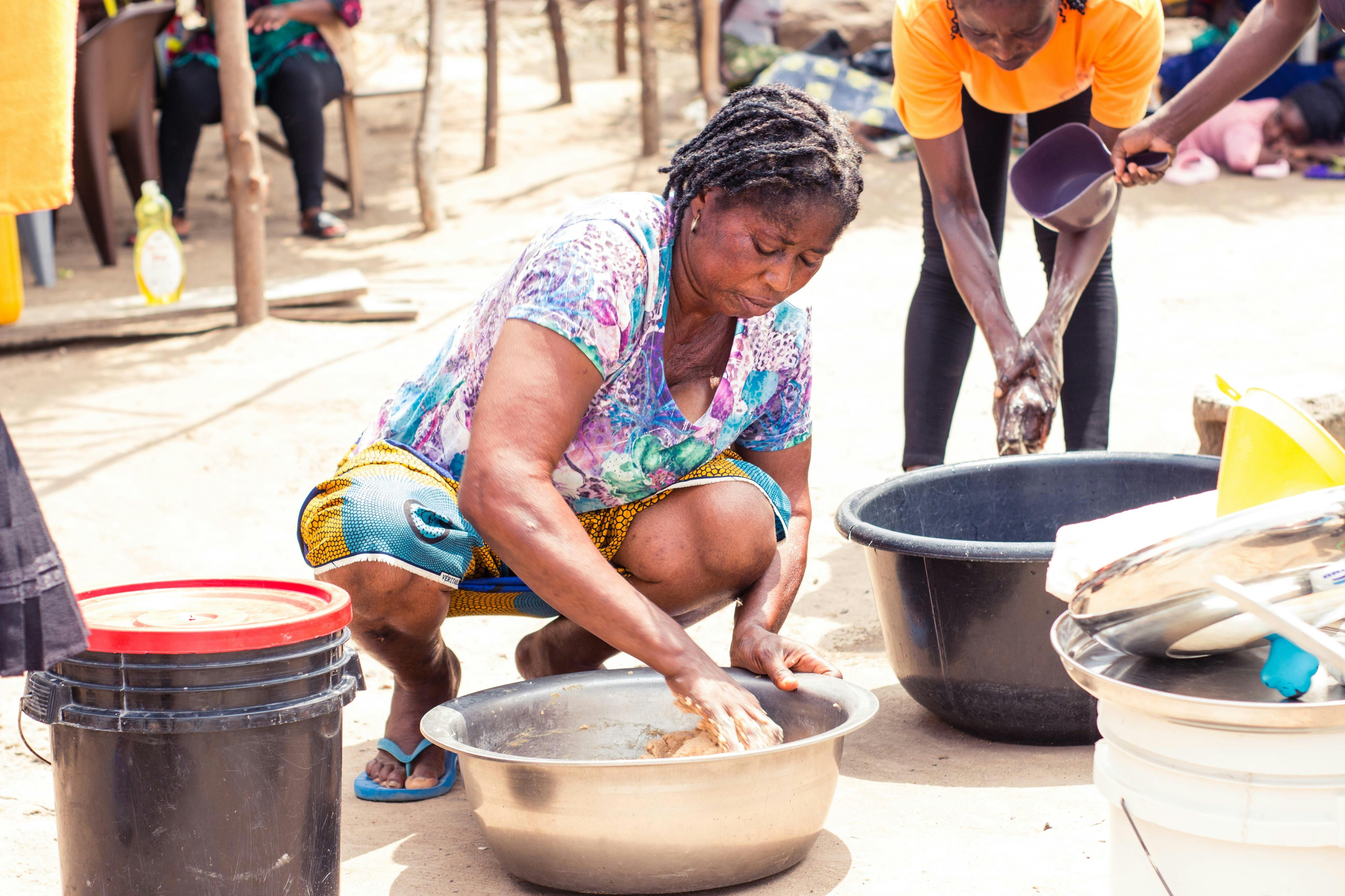 a woman is cooking food in a bowl