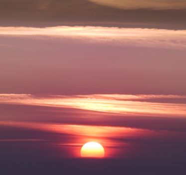 A captivating sunset with dramatic clouds and a warm glow over the horizon.