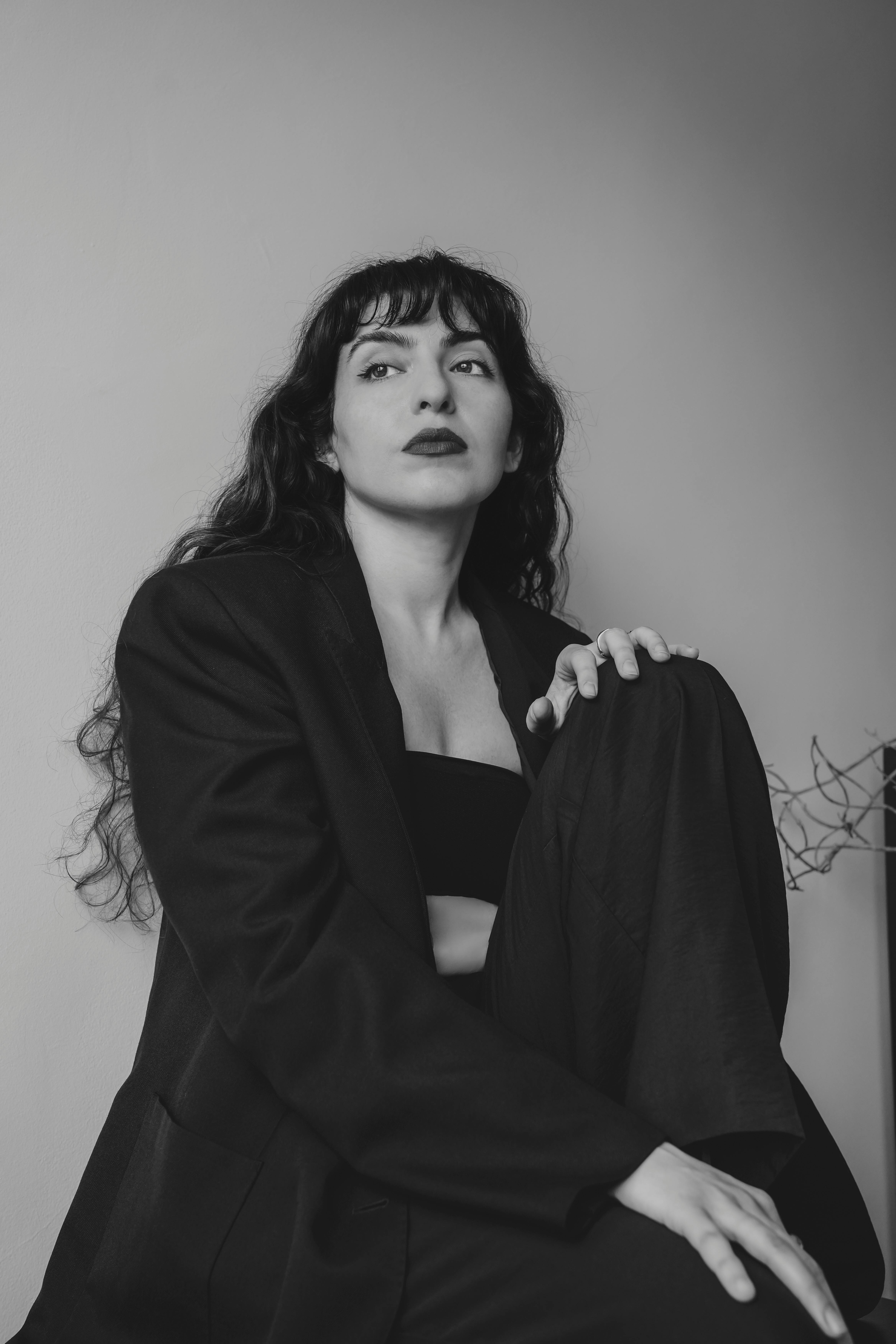 Monochrome portrait of a woman in a suit, exuding elegance and confidence.