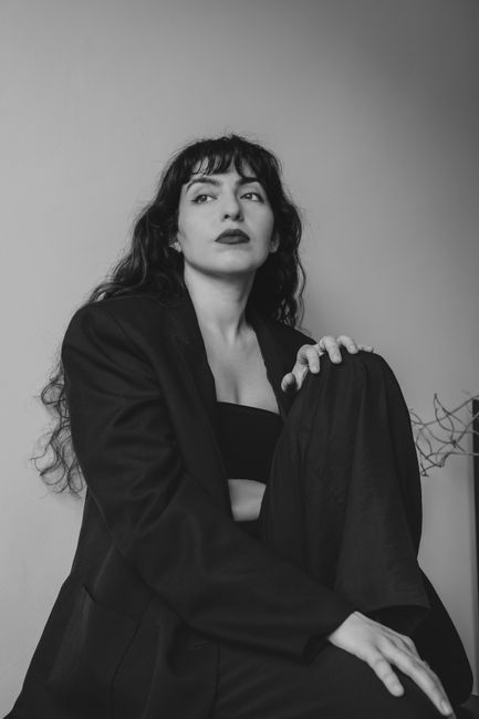 Monochrome portrait of a woman in a suit, exuding elegance and confidence.