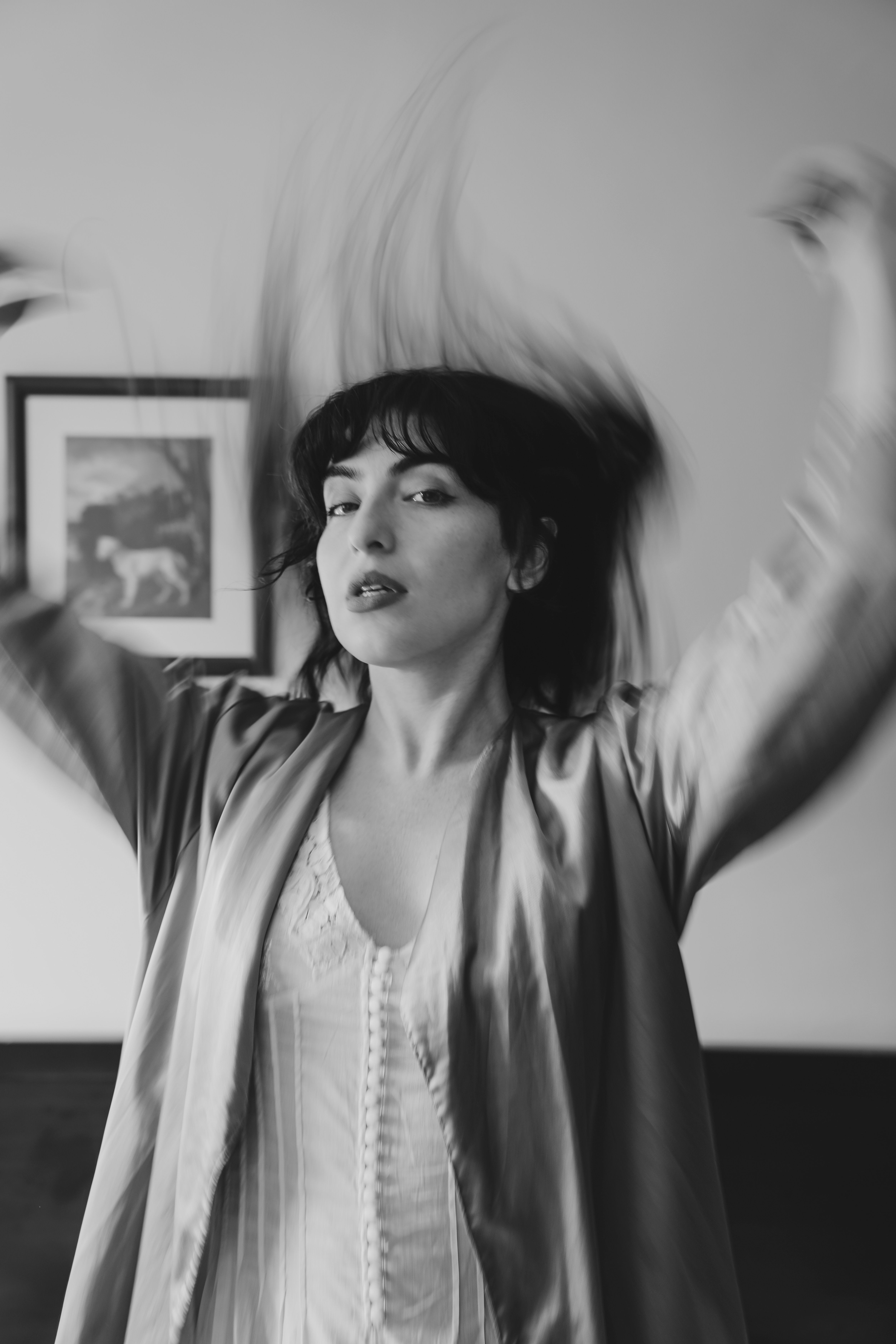 A woman in a robe is dancing in a room · Free Stock Photo