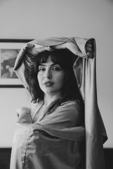Captivating monochrome portrait of a woman in a draped veil, blending elegance and nostalgia.