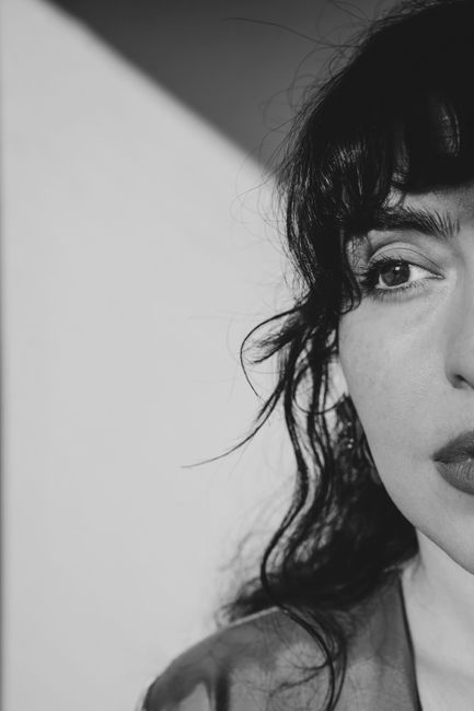 Artistic black and white portrait capturing a woman's thoughtful expression.