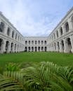 The courtyard of a building with green grass