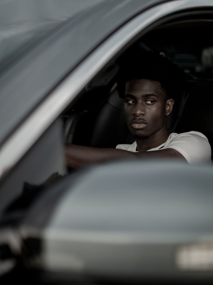 Photo Of A Man Looking Through A Car Window