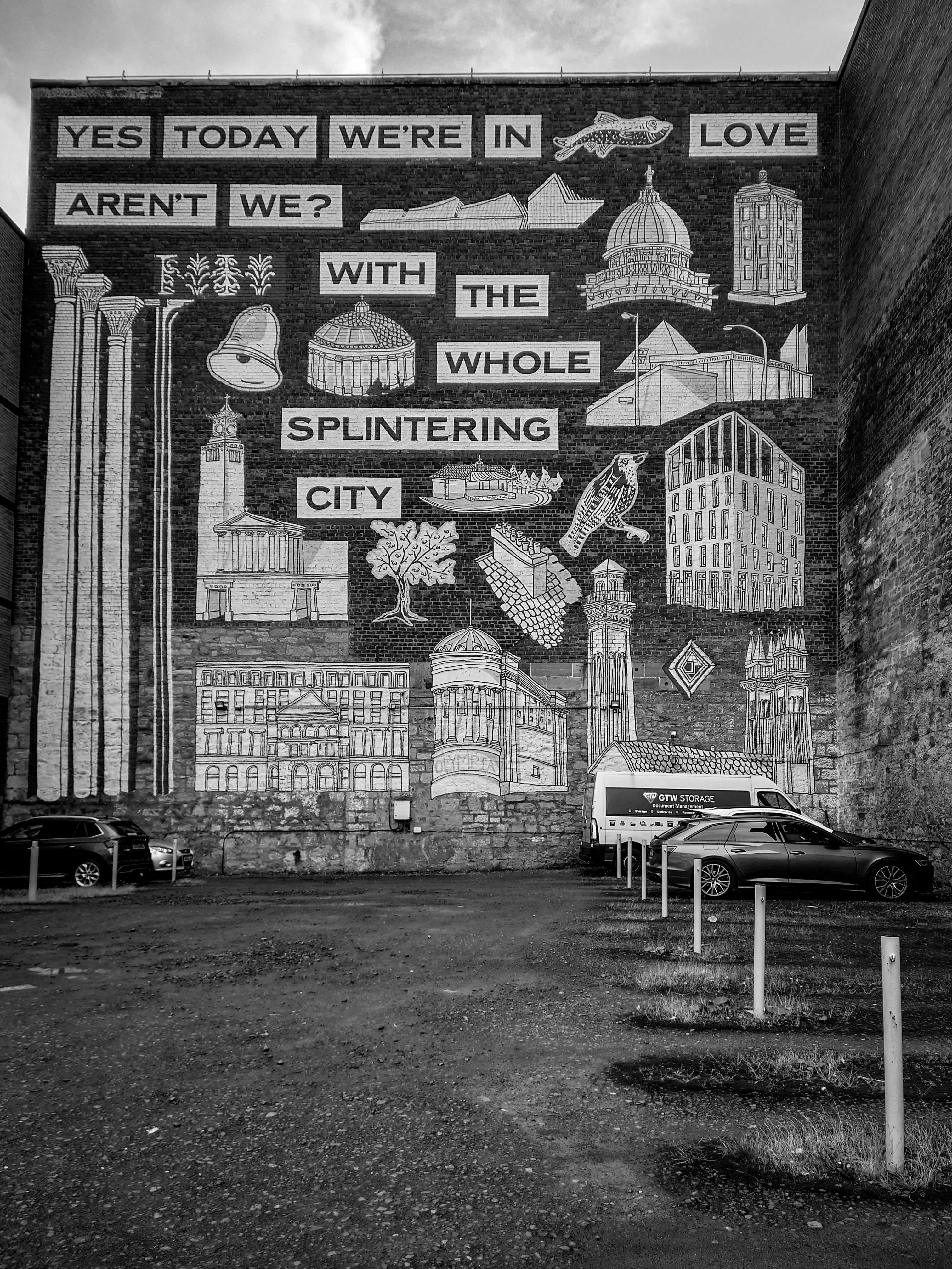 a black and white photo of a building with a large mural