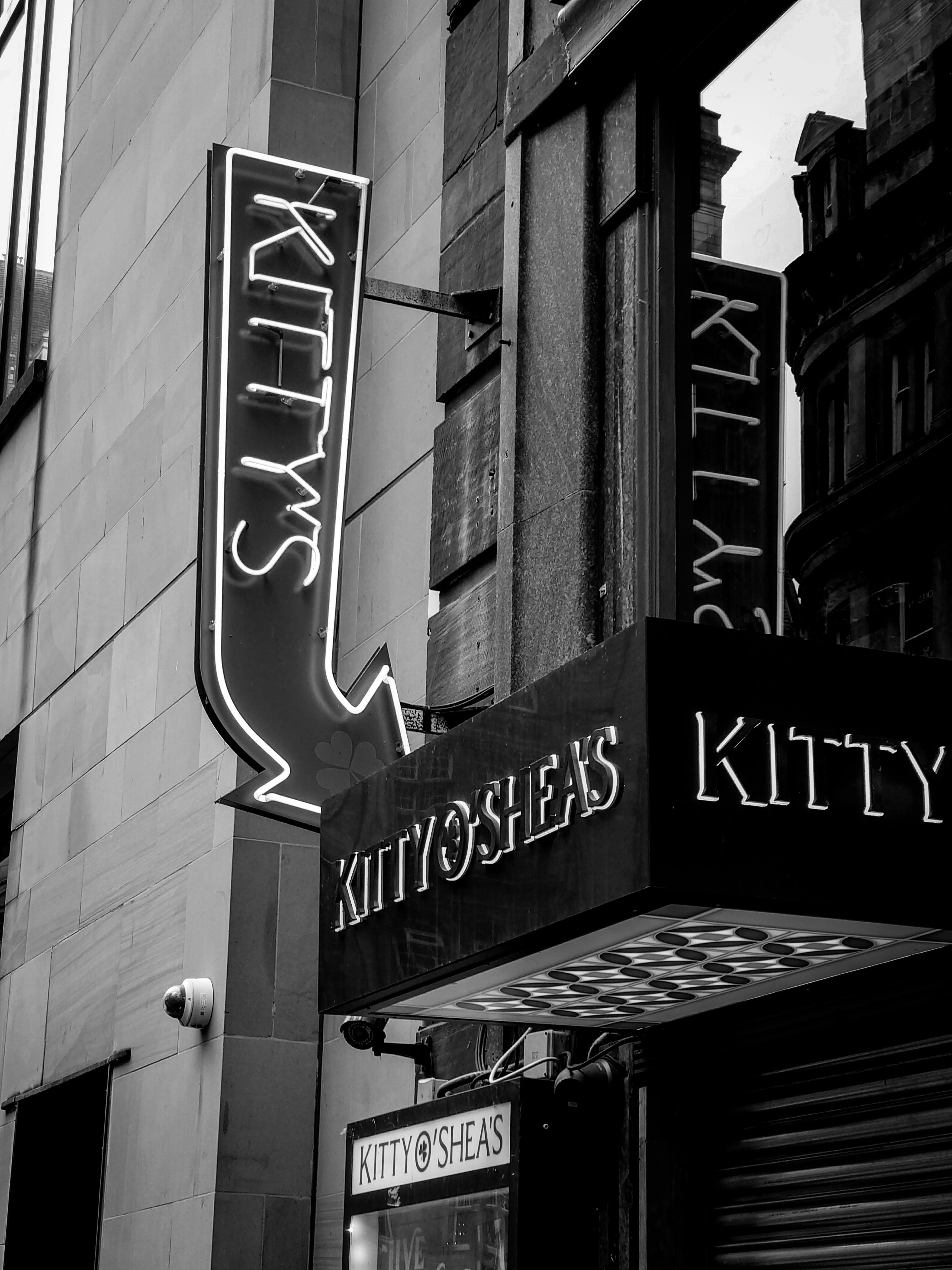 a black and white photo of a sign for kitty s