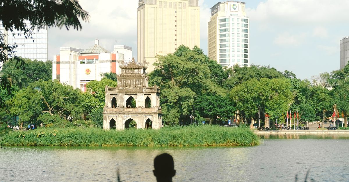 A serene view of Hoan Kiem Lake with Turtle Tower in Hanoi, Vietnam. Perfect for travel and culture themes.