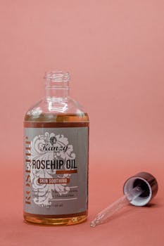 Close-up of rosehip oil bottle with dropper, ideal for skincare routines.