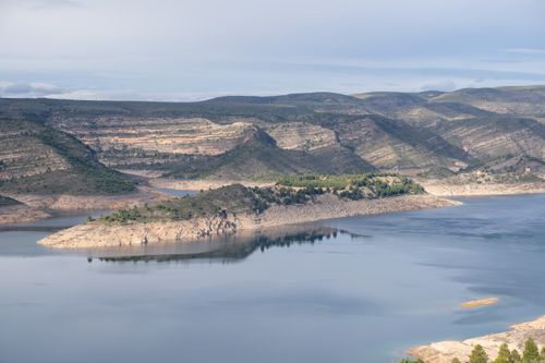 Free A tranquil panorama of Tous Reservoir in Valencia, Spain with reflections and mountainous landscape. Stock Photo