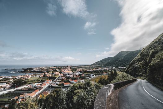 Overlooking a picturesque coastal town with mountains and ocean view on a sunny day.