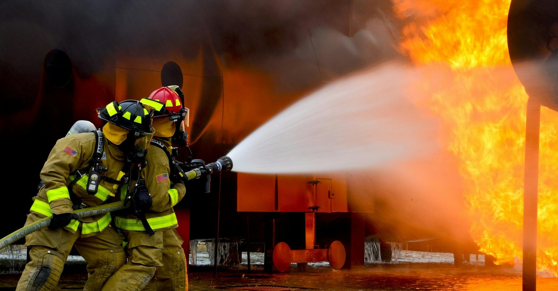 firefighter fighting fire with hose