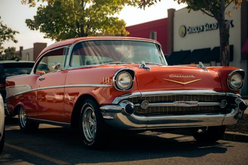 Free Close-up of a classic Chevrolet car parked outdoors on a sunny day, showcasing its shiny chrome details. Stock Photo