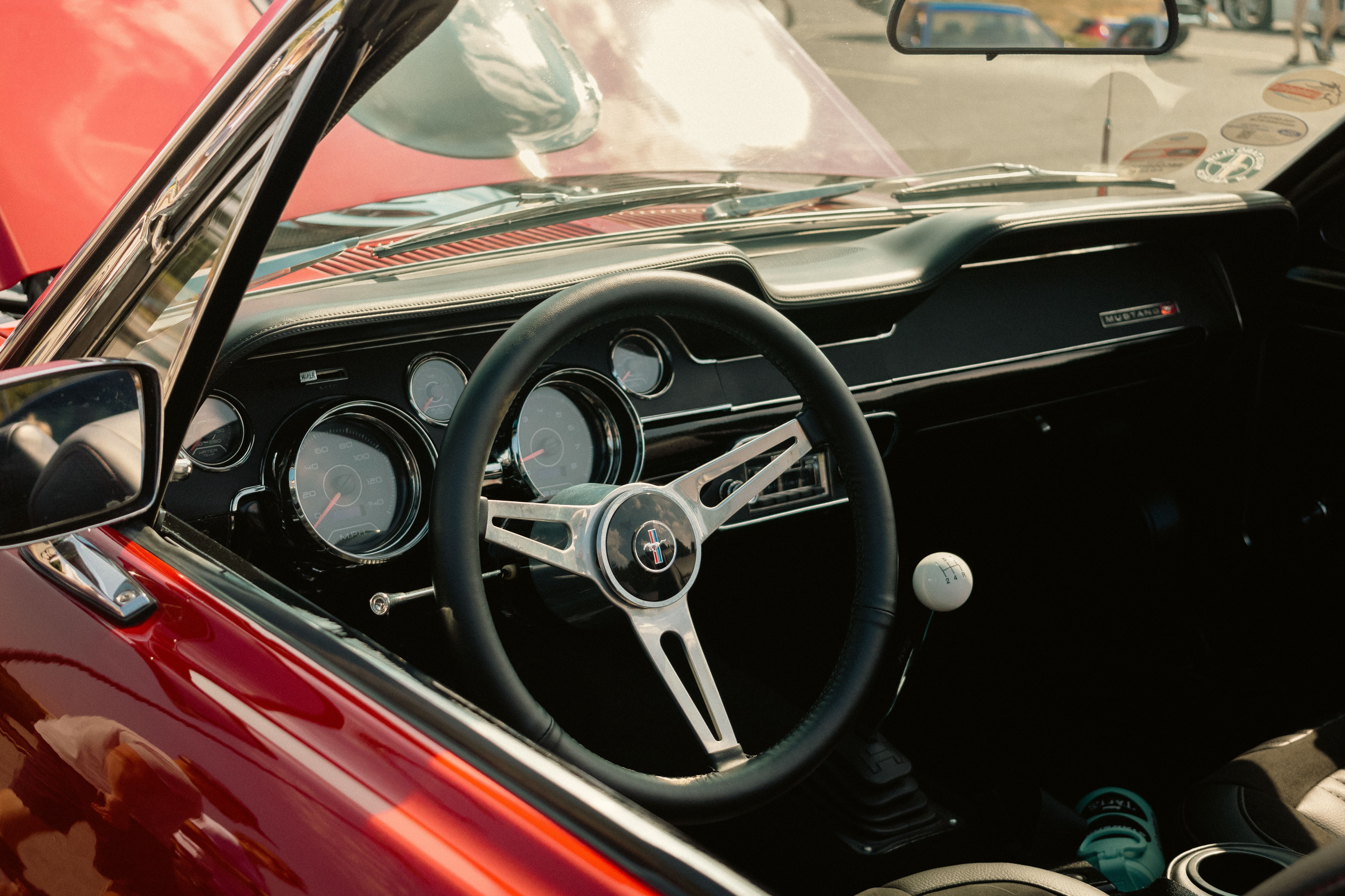 Explore the vintage design of a classic Mustang car interior featuring a stylish steering wheel and dashboard.