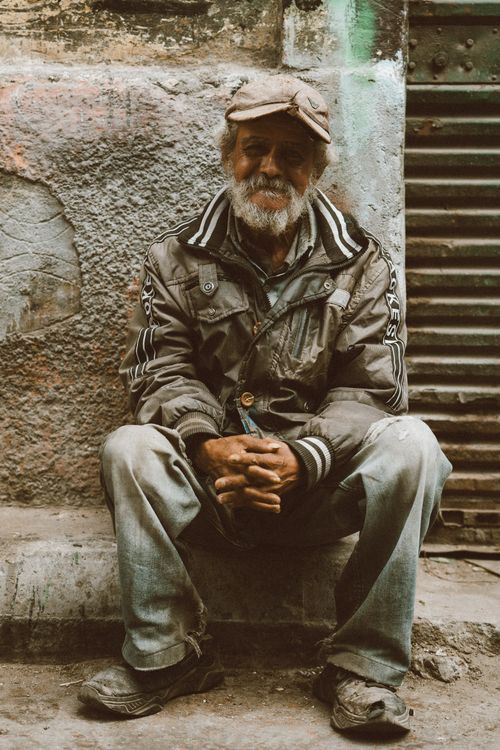 Free Elderly man with a beard sitting on a street in Alexandria, Egypt. Stock Photo