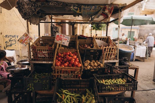 A vibrant street market in Alexandria, Egypt displaying fresh produce and local culture.