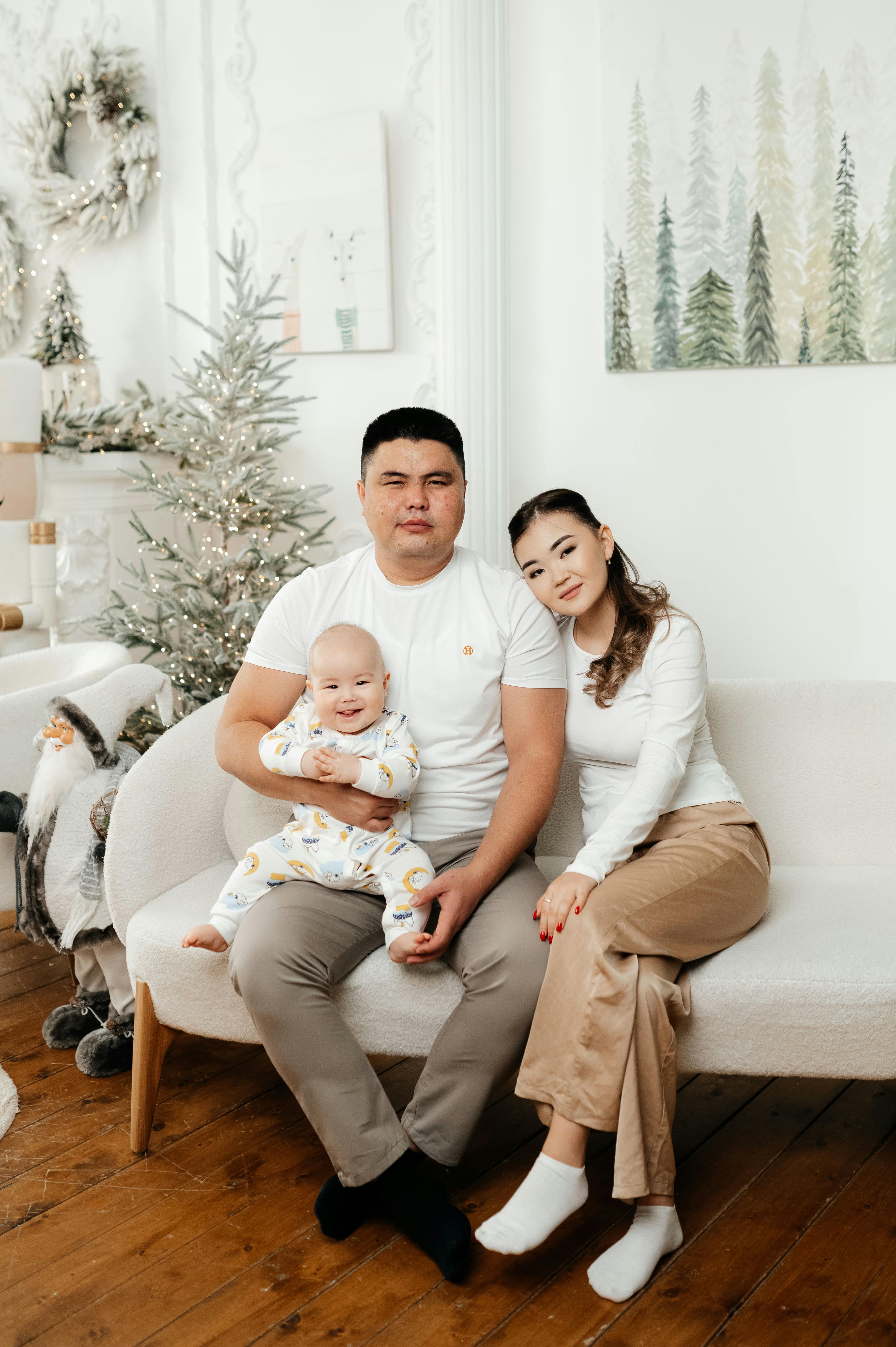 Family enjoying time together in a beautifully decorated holiday room with festive elements.