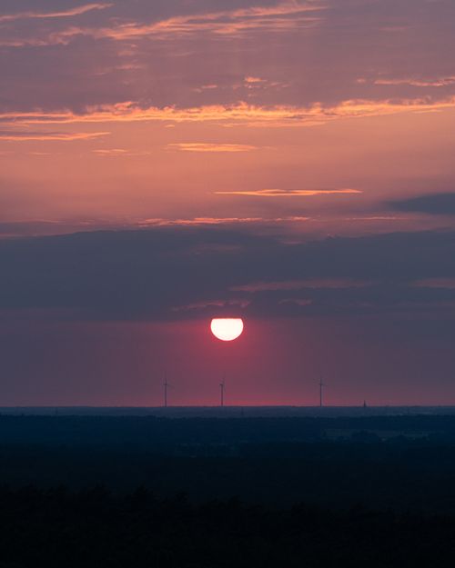 Free Vivid sunset over wind turbines, showcasing vibrant colors and serene landscapes in Reken, NRW. Stock Photo