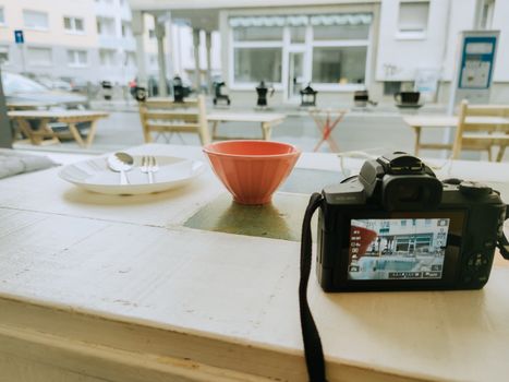 Cozy café with a camera and table setting, ideal for photography enthusiasts.
