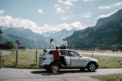 Photo Of People On SUV During Daytime