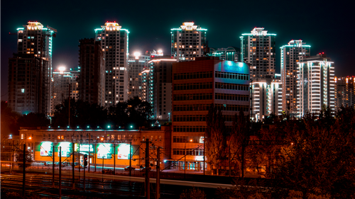 Free A vibrant city skyline with illuminated skyscrapers against the night sky. Stock Photo