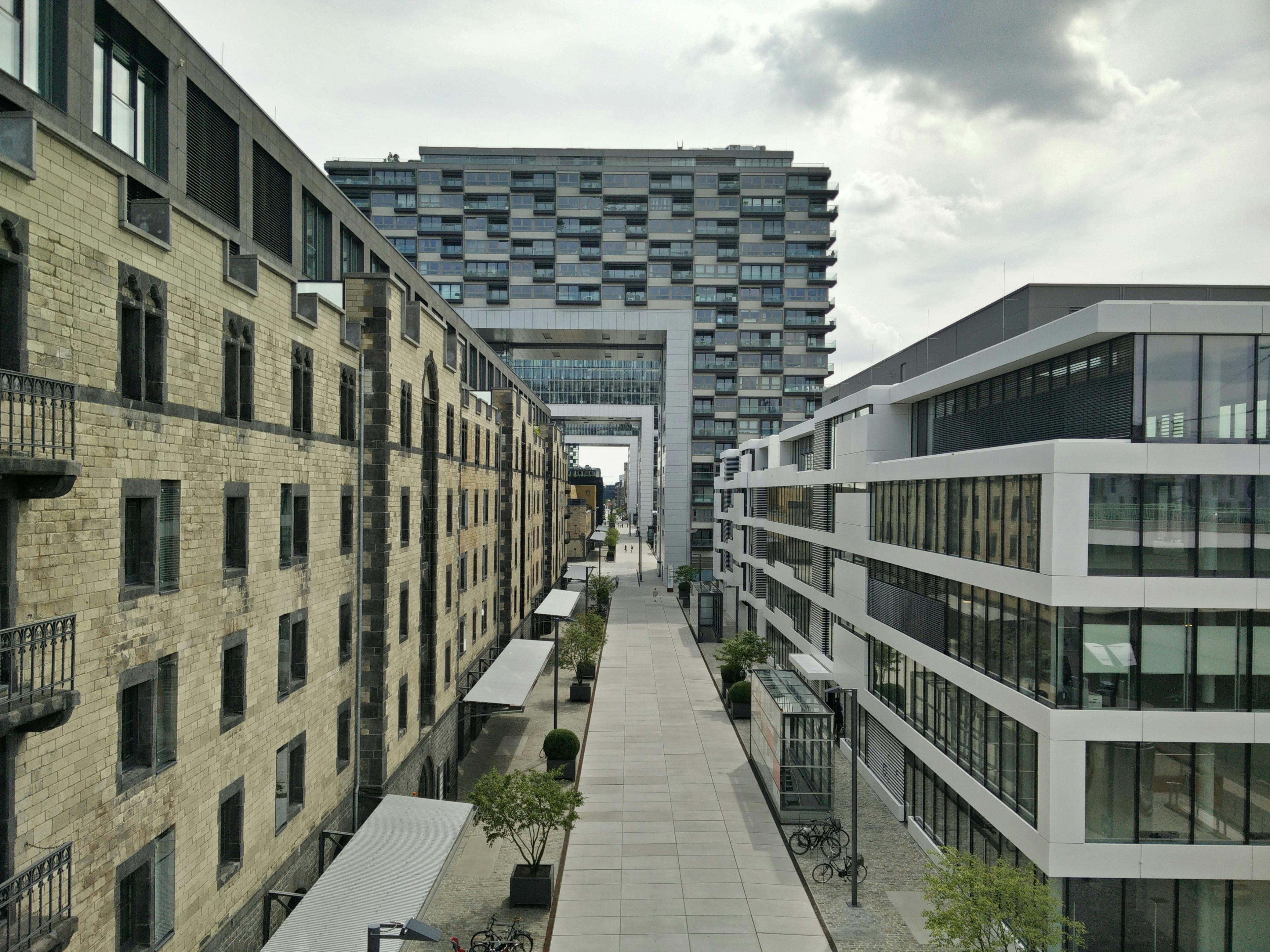 Free Pathway Between White And Brown High-Rise Buildings Stock Photo