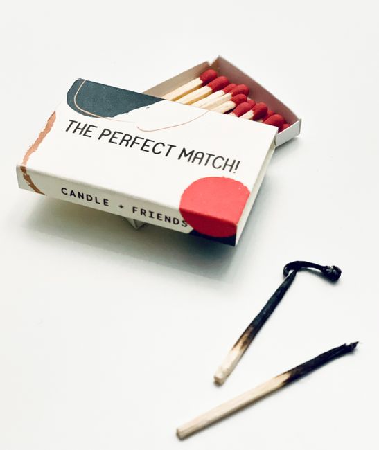 A stylish matchbox with burnt and unused matches, emphasizing safety and creativity.