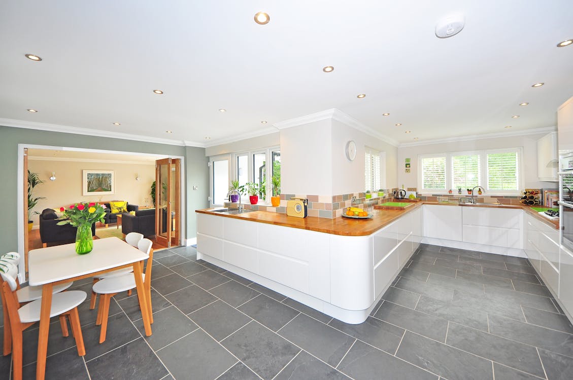 new flooring, cabinets, and fixtures in a white kitchen