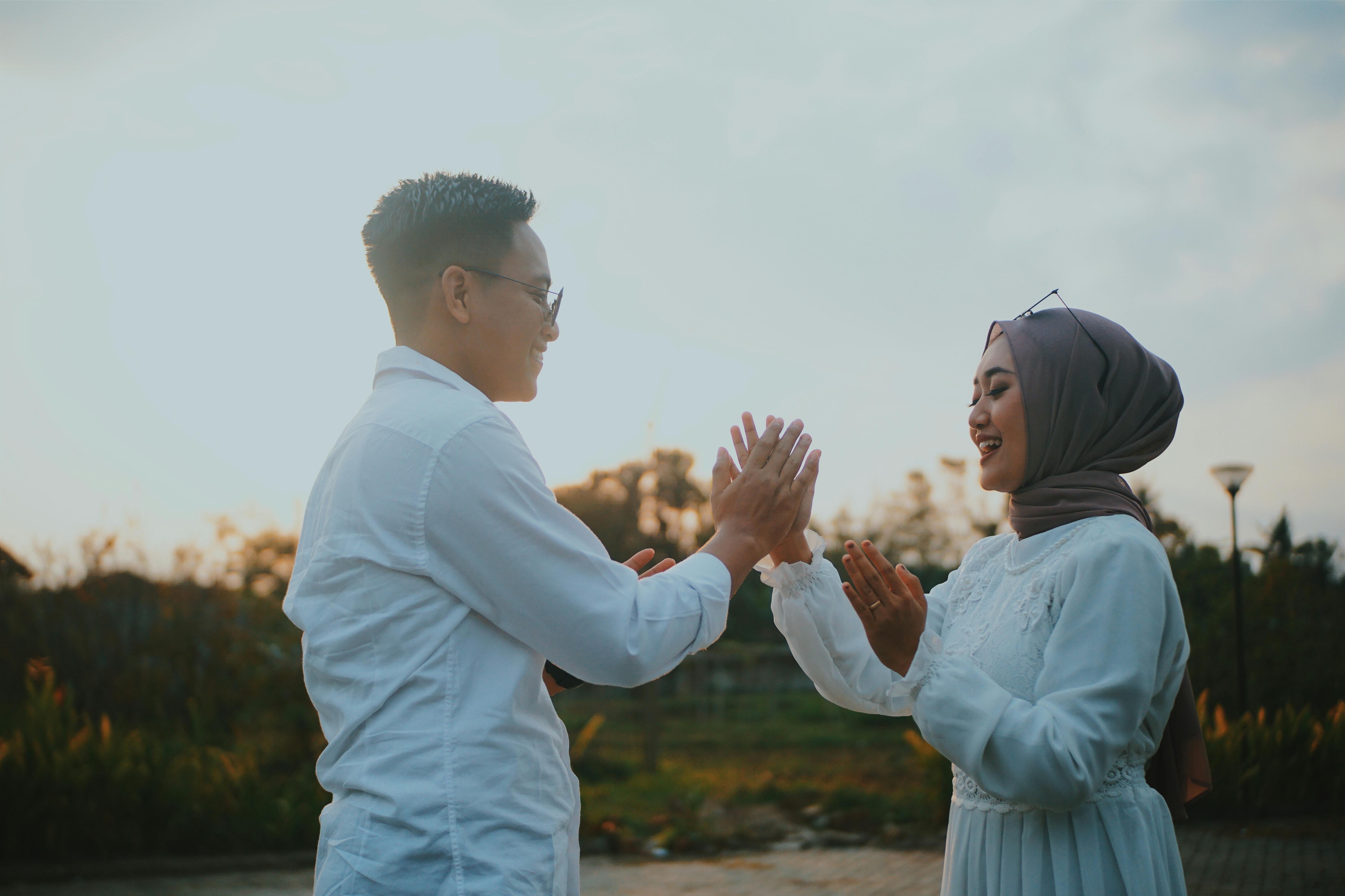 man and woman wearing white tops