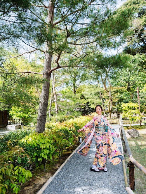 Woman Wearing Kimono Dress Standing on Pathway