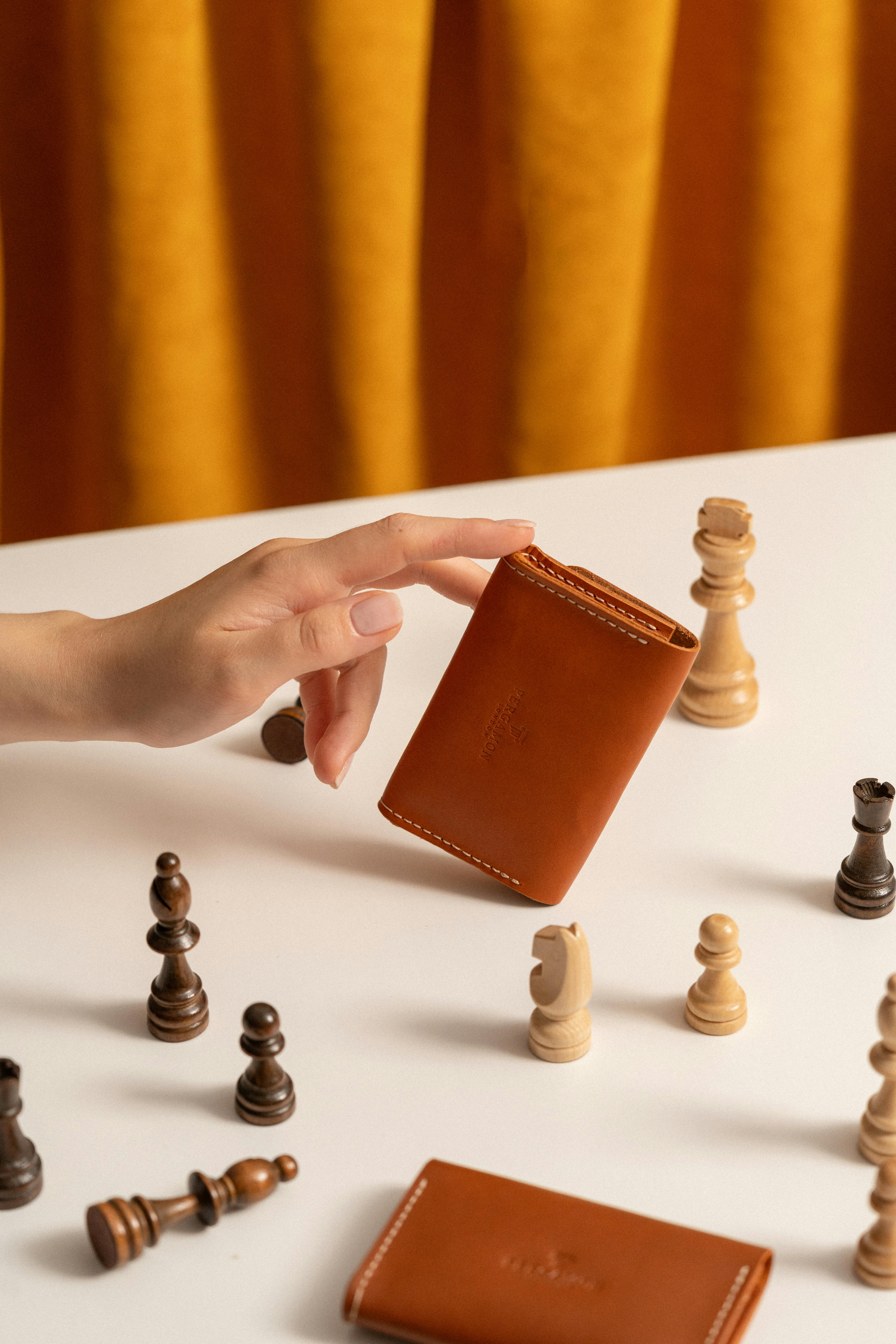 hand of a woman holding a leather purse