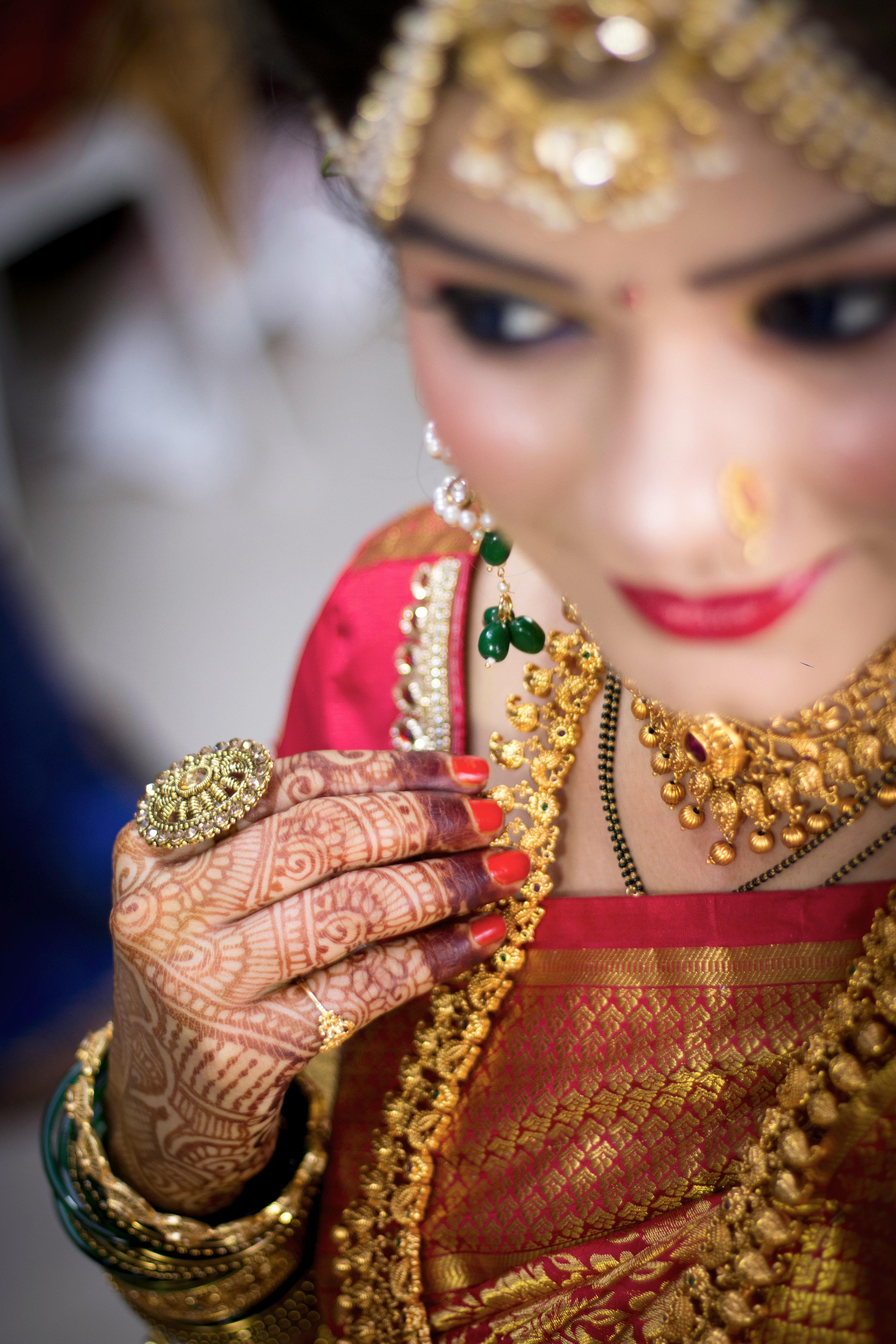 Woman Wearing Traditional Clothing and Mehendi Posing under a Garland ·  Free Stock Photo