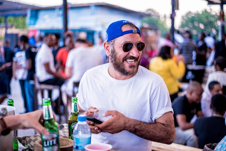 Man Wearing Blue Cap And White Shirt