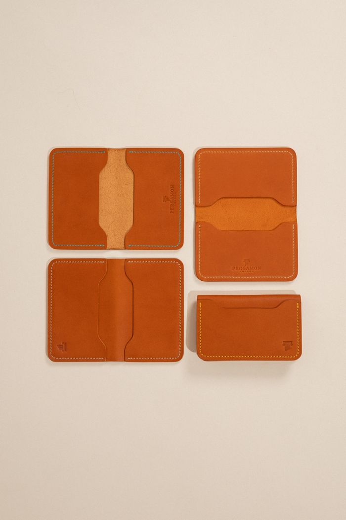 Minimalist leather wallets on a beige backdrop, by Gül Işık on Pexels