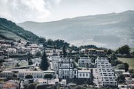 Picturesque view of Horta in the Azores, featuring traditional architecture and lush hills.