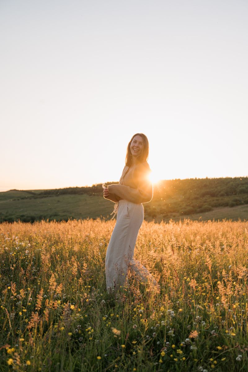 A woman in a field at sunset · Free Stock Photo