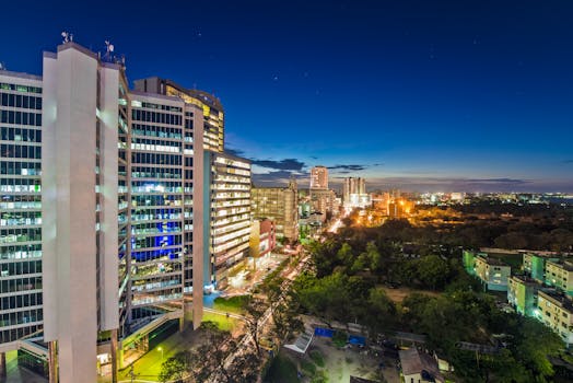 Dynamic night skyline of Dar es Salaam, showcasing illuminated city architecture.
