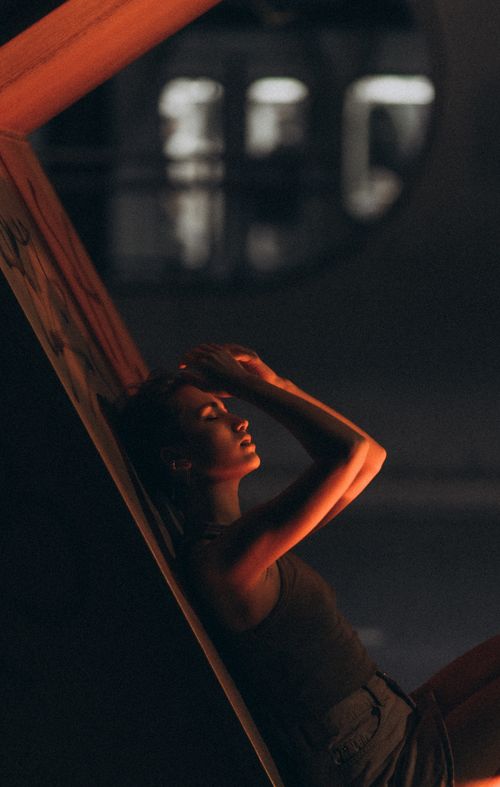 Free Artistic portrait of a woman in dramatic lighting, posing at night with a moody ambiance. Stock Photo