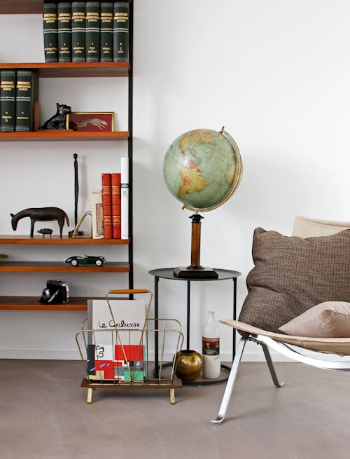 Free Desk Globe on End Table Beside Chair Stock Photo