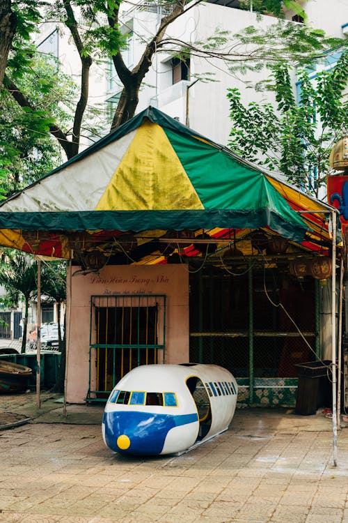 Toy Airplane with Seats for Children in Front of Stall