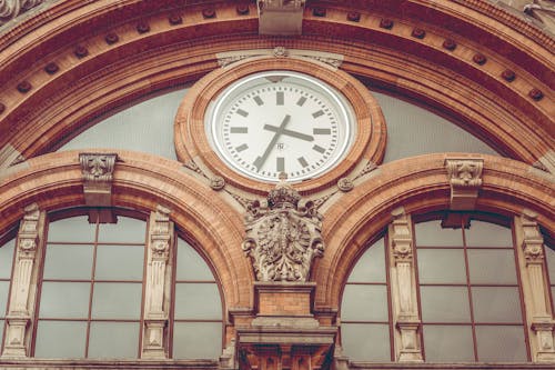 Free Brown Concrete Hall With Clock Stock Photo