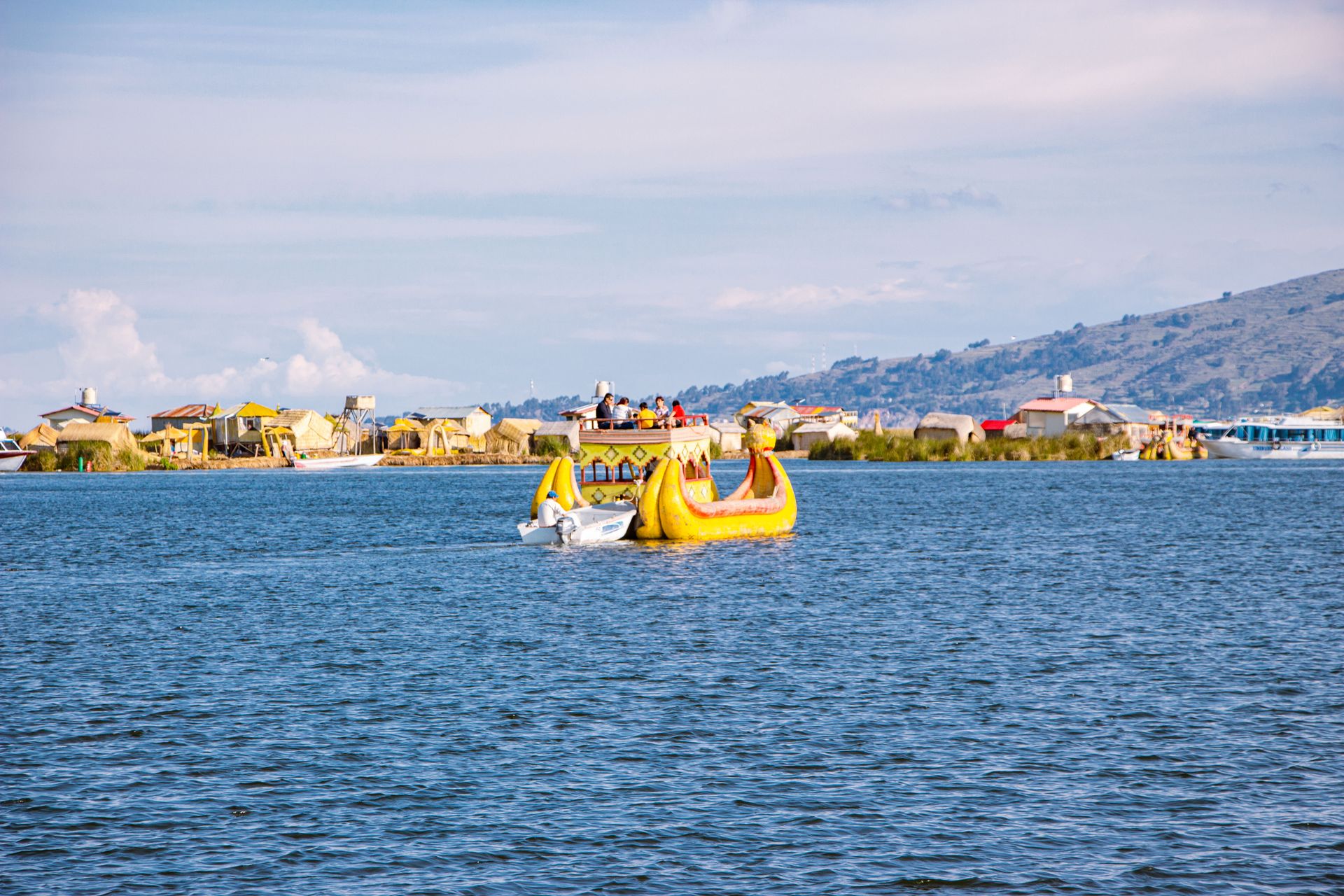 Vibrant scene of reed boats navigating Lake Titicaca near the Uros Floating Islands in Peru.
