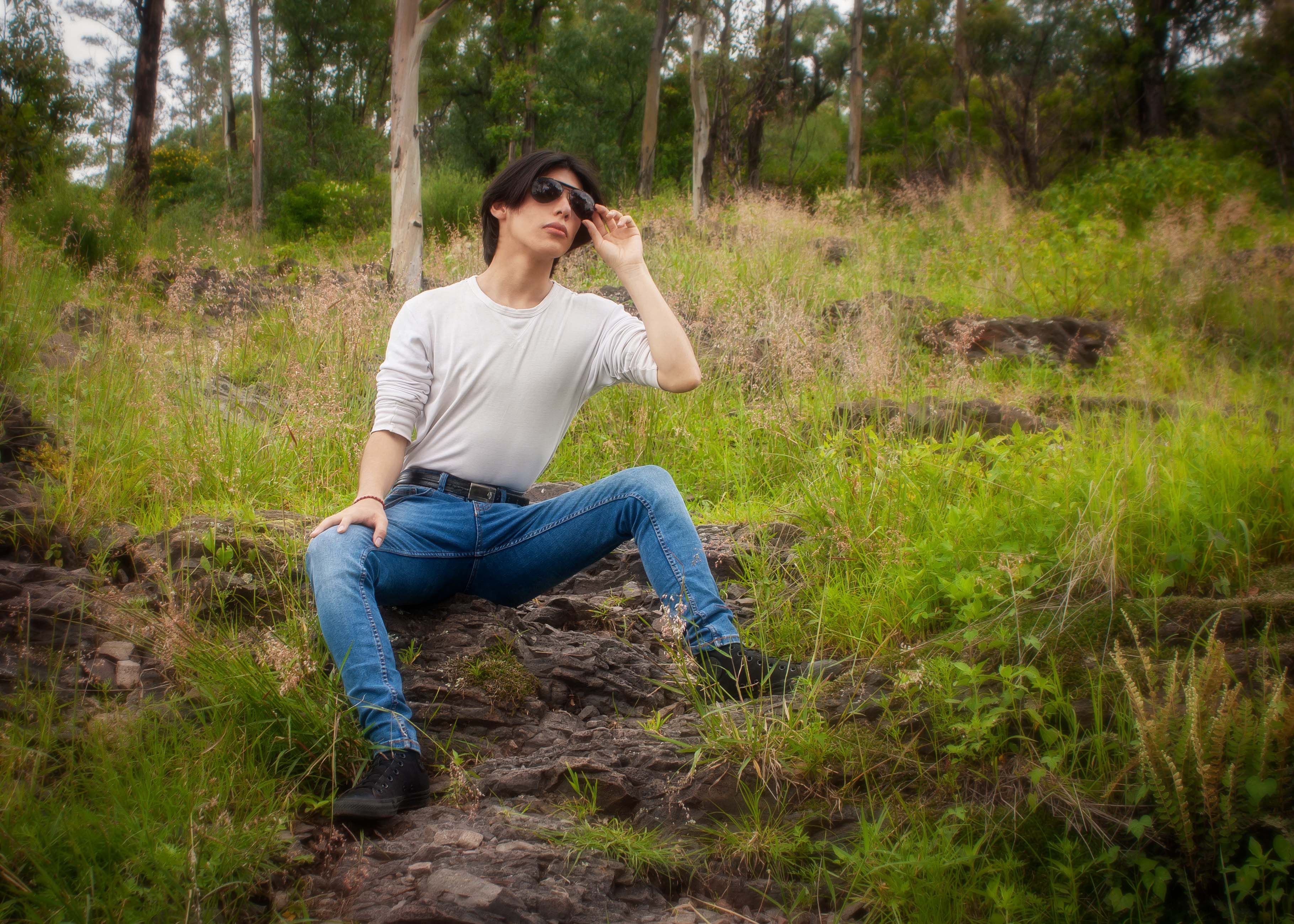 A woman sitting on a rock in the woods · Free Stock Photo