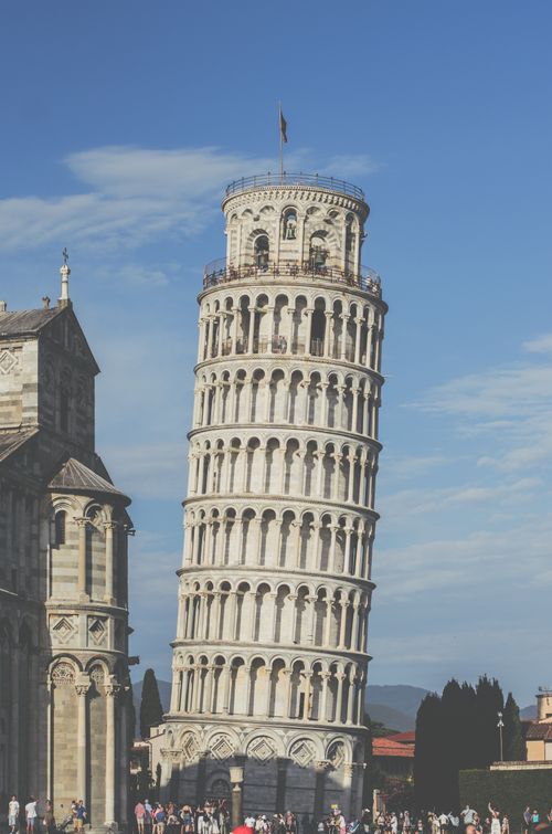 Free The historic Leaning Tower of Pisa in Italy's Piazza dei Miracoli, bathed in sunlight. Stock Photo