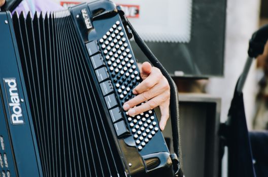Close-up of a street musician's hands playing an accordion in Nuremberg, Germany.