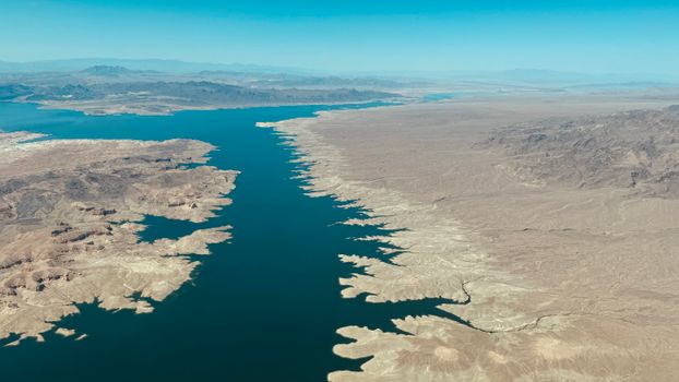 Expansive aerial view showing Lake Mead along the Colorado River with a desert landscape.