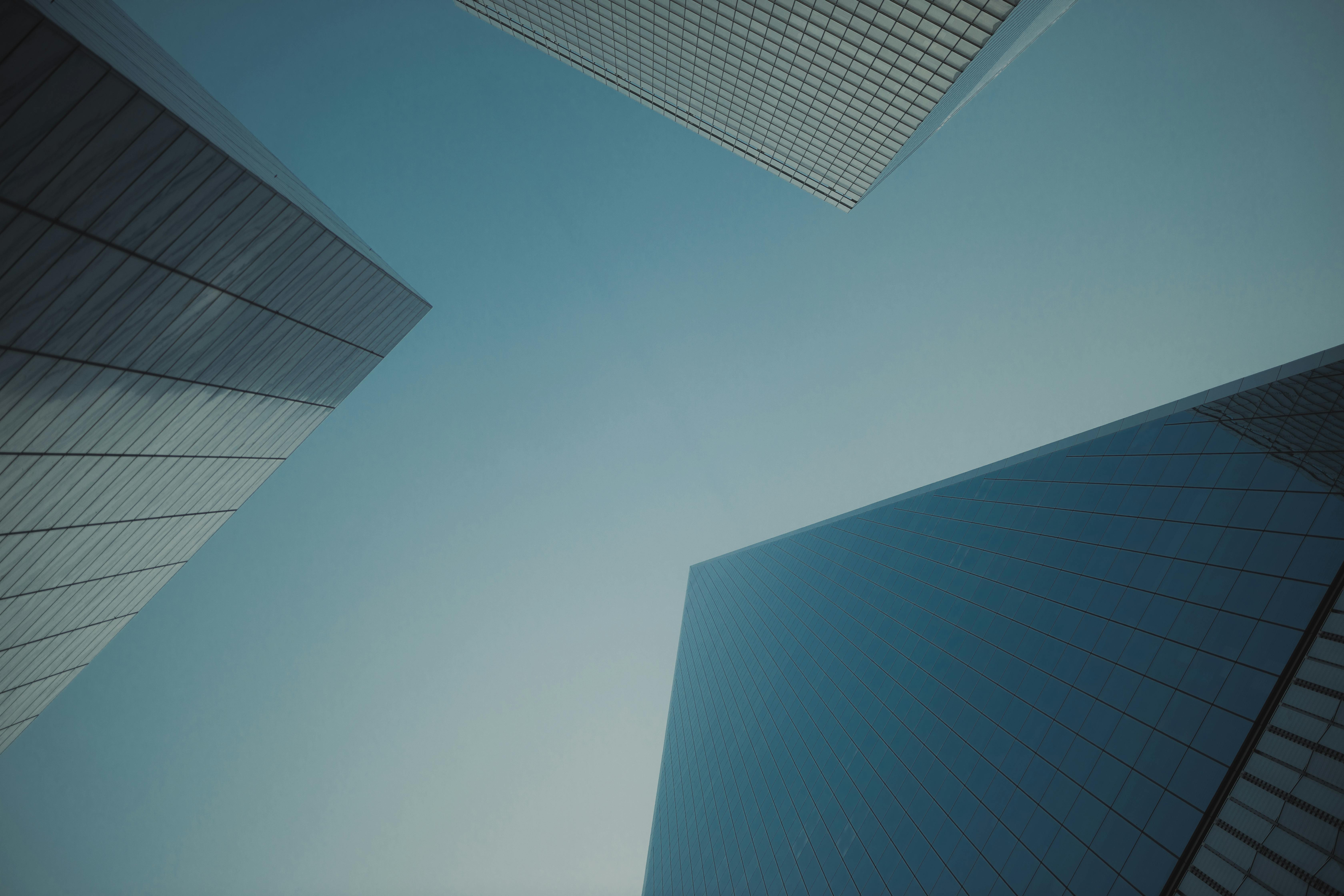 Abstract view of modern skyscrapers against a clear blue sky, showcasing urban architecture.
