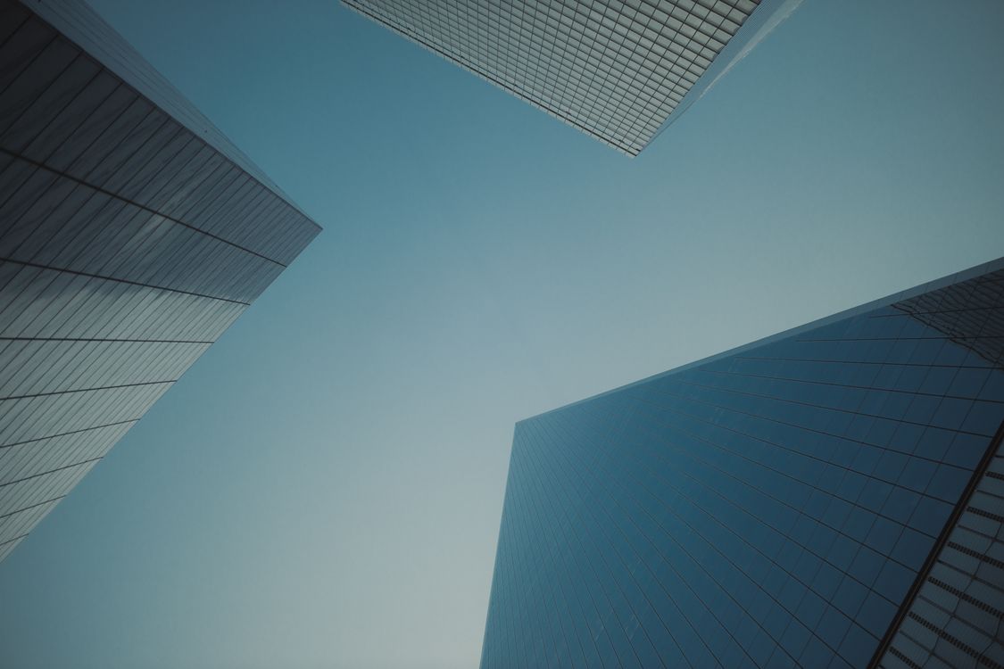 A view of tall buildings from the ground · Free Stock Photo