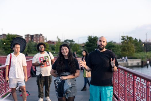 A group of diverse people enjoying a meetup on a bridge in Chicago, capturing togetherness and friendship.