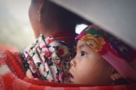 A heartwarming scene of a mother and child in vibrant traditional clothing in Lào Cai, Vietnam.